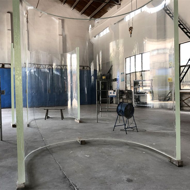 the inside of an industrial building with metal pipes and large mirrors on the wall,