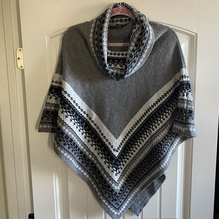 Gray And Black Poncho Size: One Size Never Worn Gray Long Sleeve Winter Cape, Casual Black Poncho For Cold Weather, Cozy One Size Gray Outerwear, Cozy Gray One-size Outerwear, Oversized Gray Poncho For Winter, Oversized Gray Poncho For Fall, Gray Oversized Poncho For Winter, Gray Poncho For Cold Weather In Fall, Casual Gray Long Sleeve Poncho