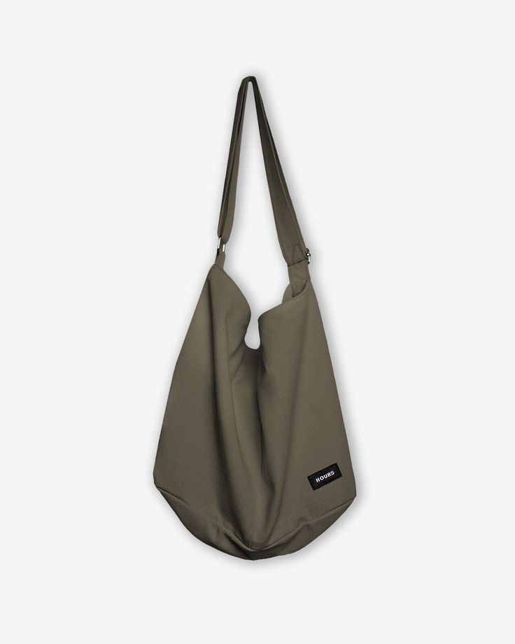 This vintage inspired high capacity tsuno bag is made from 100% cotton canvas material and features a slouchy fit. It features a large pocket with zip closure and interior open pockets. It is perfect to wear over the shoulder or across your body and can fit all your everyday essentials. 100% Cotton Adjustable strap One-size Casual Shoulder Bag With Pockets For Weekend, Casual Weekend Shoulder Bag With Pockets, Weekend Cotton Bag With Pockets, Weekend Cotton Bags With Pockets, Cotton Weekend Bag With Pockets, Casual Shoulder Bag With Canvas Lining For Weekend, Casual Canvas-lined Shoulder Bag For Weekend, Hobo Canvas Bag With Pockets, Khaki Cotton Shoulder Bag For Daily Use