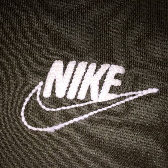 the nike logo is white on a black shirt