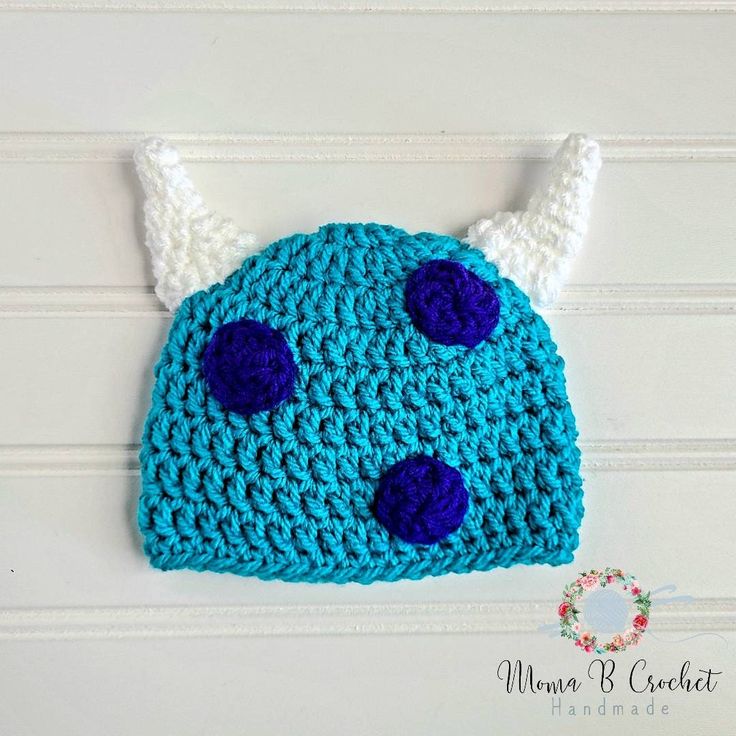 a crocheted hat with horns and blue eyes