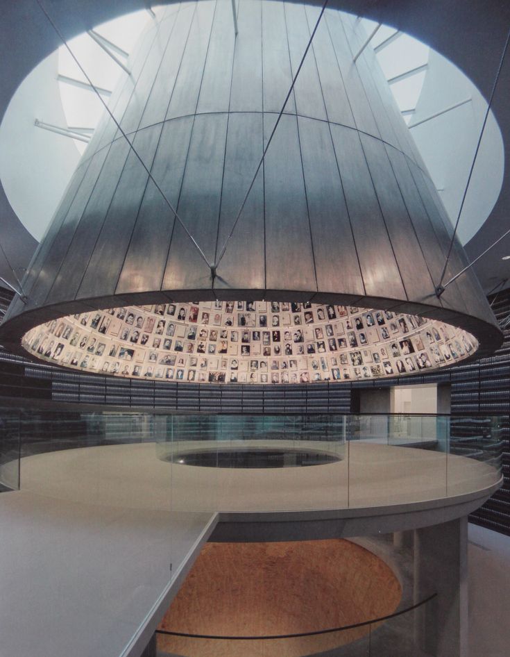 the inside of an office building with pictures on the wall and round window above it