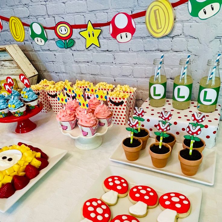 a table topped with lots of cupcakes and cakes