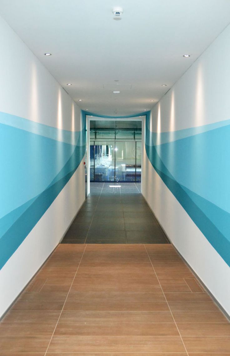 an empty hallway with blue and white painted walls