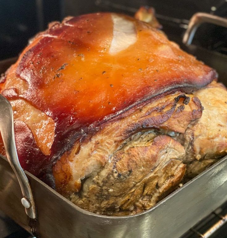 a roasting pan filled with meat in the oven