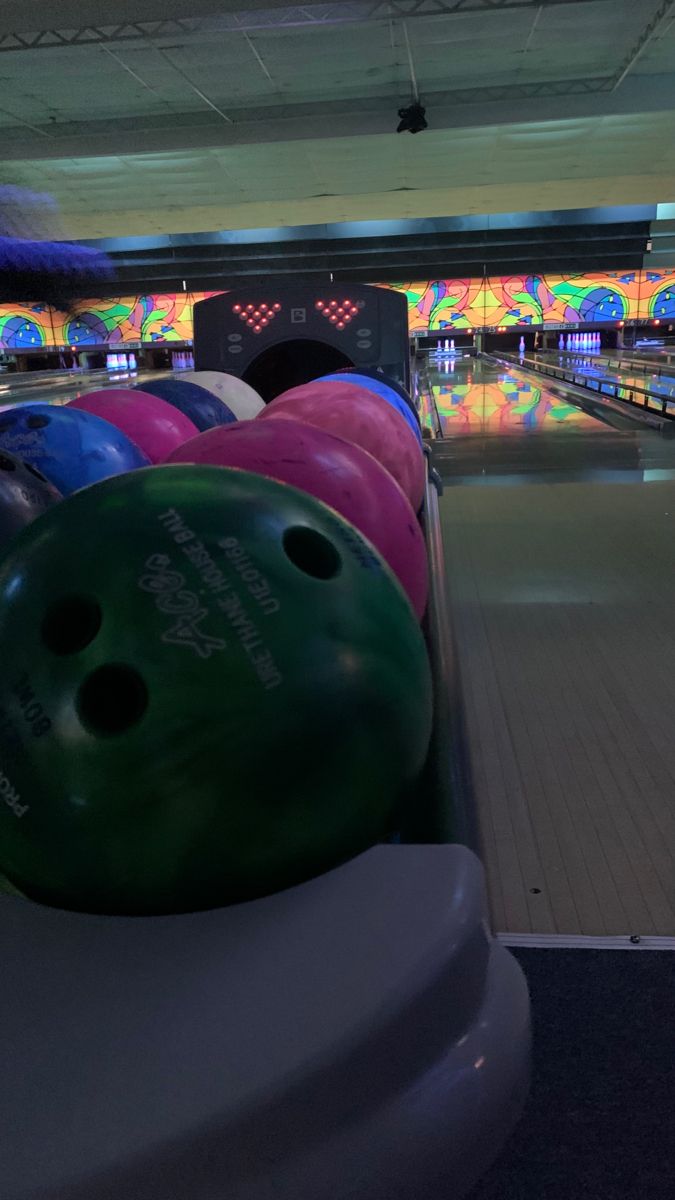 the bowling alley is full of colorful bowling balls