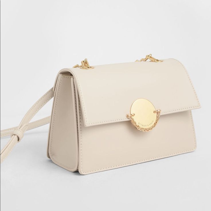 New Classical Beige Chain Crossbody Bag From Charles & Keith. Front Flap With Push-Lock Closure Chain Link Detail Comes With Adjustable Strap (Detachable) Material: Faux Leather Depth (Cm): 11.5 Width (Cm): 22 Height (Cm): 14.5 Come With Original Dust Bag. Elegant Cream Bag With Chain Strap, Silver Crossbody Bag With Gold-tone Hardware, Classic Silver Crossbody Shoulder Bag, Classic Silver Shoulder Bag With Chain Strap, Classic Silver Bag With Chain Strap, Elegant Flap Shoulder Bag With Chain Strap, Elegant Shoulder Flap Bag With Chain Strap, Formal Cream Shoulder Bag With Chain Strap, Beige Crossbody Evening Bag With Chain Strap