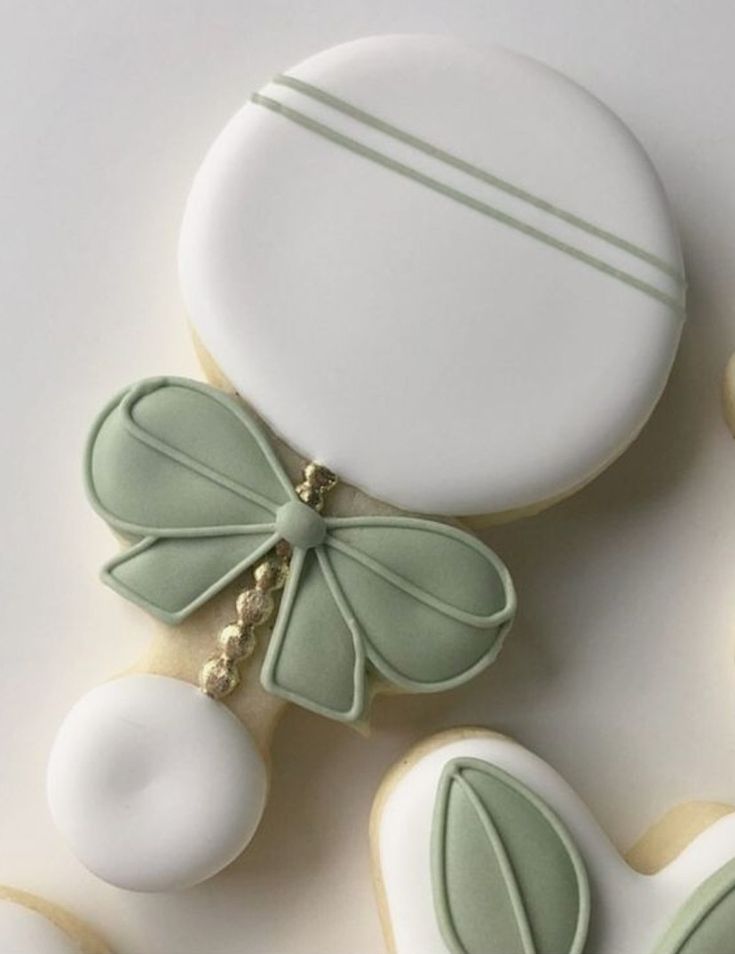 cookies decorated with green leaves and white frosting