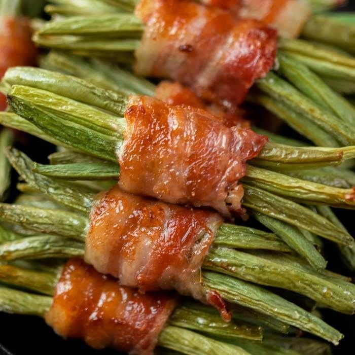 green beans wrapped in bacon sitting on top of each other