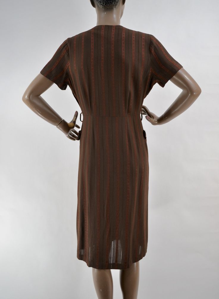 "50's super soft woven dress. Rich brown, with brick red striped pattern. In between stripes are woven alternating stiching to create a checkerboard pattern with negative space, and a little peek-a-boo to the skin. Darling button collar and outside front pockets Slight fading under armpits. In excellent used condition. No belt. 15\" shoulders 12\" sleeve 40\" chest 30\" waist 40\" hips 42\" length" Retro Brown Midi Dress, Vintage Brown Lined Dress, Retro Brown Lined Dress, Retro Brown Dress For Fall, Vintage Brown Short Sleeve Dress, Retro Brown Short Sleeve Dress, Brown Vintage Short Sleeve Dress, Vintage Brown Midi Dress For Fall, Vintage Brown Midi Length Dress