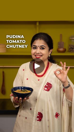 a woman holding a bowl with food on it and the words puduna tomato chutney in front of her