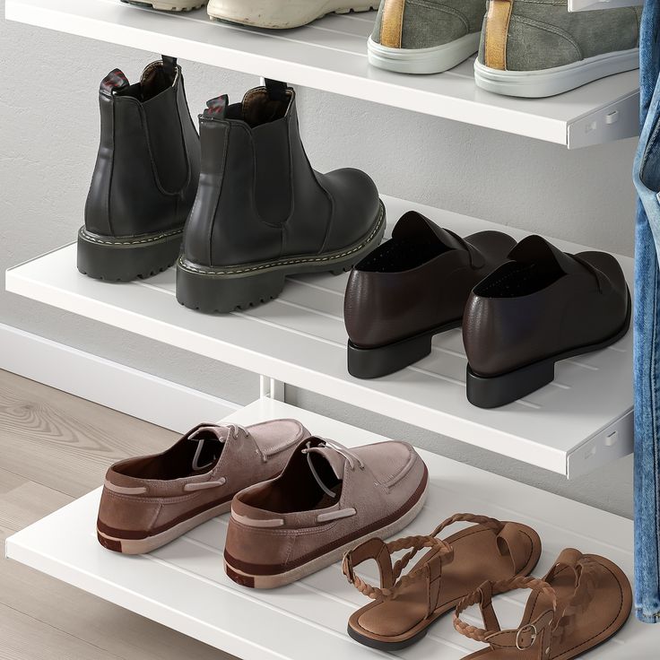 several pairs of shoes are lined up on the shelf in front of a pair of jeans