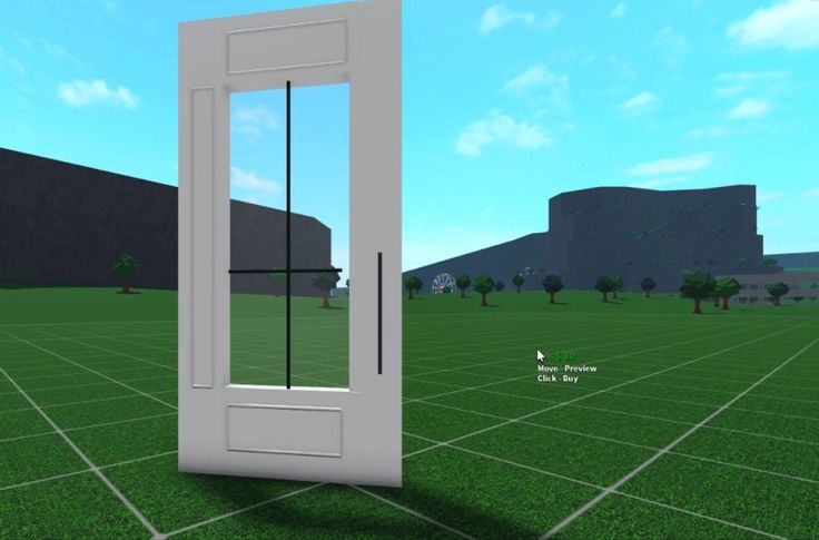 an open door in the middle of a grassy field