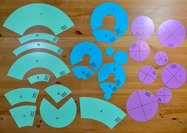 several pieces of paper cut out to look like circles and numbers on a wooden surface