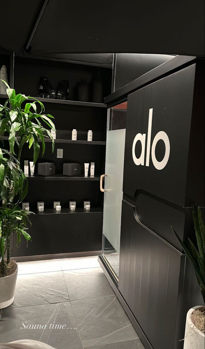 an alo store with plants in the corner