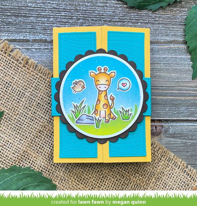 a card with a giraffe on it sitting next to some leaves and grass