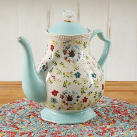 a tea pot sitting on top of a rug