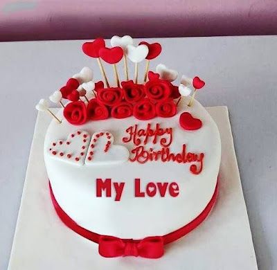 a birthday cake decorated with red and white decorations