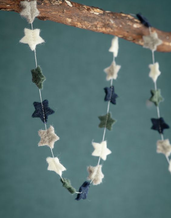 some little stars hanging from a tree branch