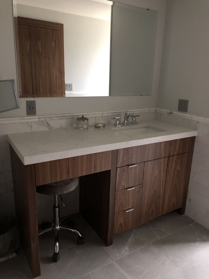 a bathroom vanity with two sinks and mirrors