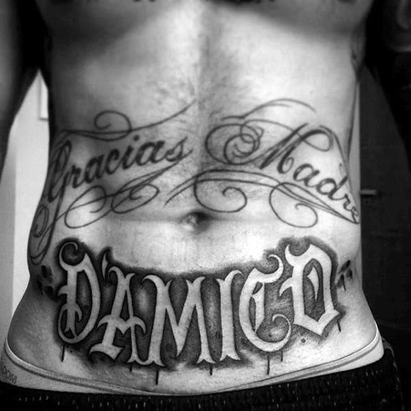 a man's stomach with the word danger tattooed on it, and his name in cursive writing