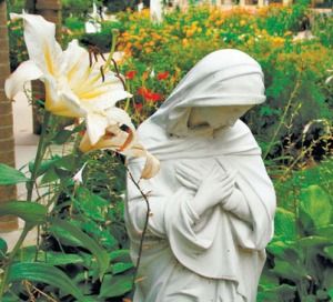 a statue of a person holding a flower