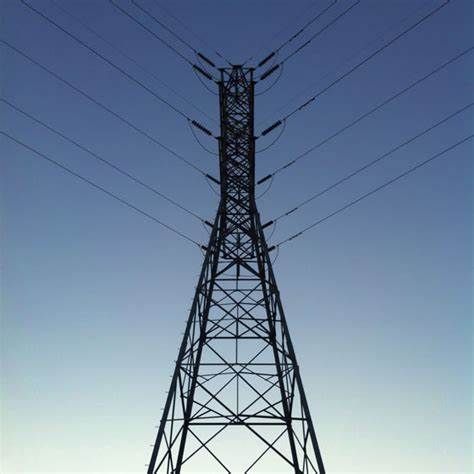 an electric tower with power lines above it