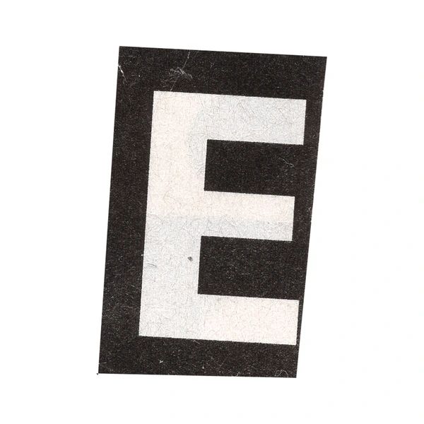 the letter e is made up of black and white paper with letters that spell it out