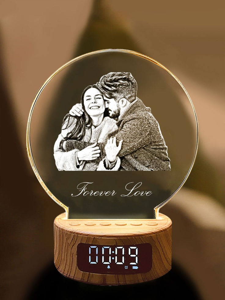 a glass clock with an image of a man and woman hugging each other on it