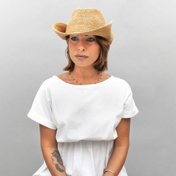 Introducing the Belfry Llina, the ultimate hat for those looking to channel a western, casual style. Made with raffia straw, this packable hat features an adjustable and tieable chinstrap, allowing for versatile wear. FEATURESStyle: Outdoor with Snap-Up BrimMaterial: 100% Raffia Dimensions: 4" Crown, 3" BrimNotes: Brim can be attached to the crown of the hat via snap fasteners on each side. Summer Brown Straw Hat For Ranch, Brown Summer Straw Hat For Ranch, Brown Summer Straw Hat For The Ranch, Brown Straw Hat For Ranch In Summer, Summer Country Style Straw Hat In Toquilla, Summer Country Style Straw Hat In Toquilla Straw, Summer Country Straw Hat In Toquilla Straw, Country Style Summer Straw Hat In Toquilla Straw, Country Style Natural Hat Bands For Summer