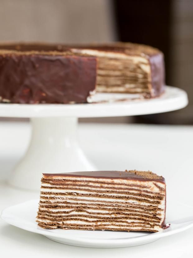 a piece of cake sitting on top of a white plate next to a slice of cake