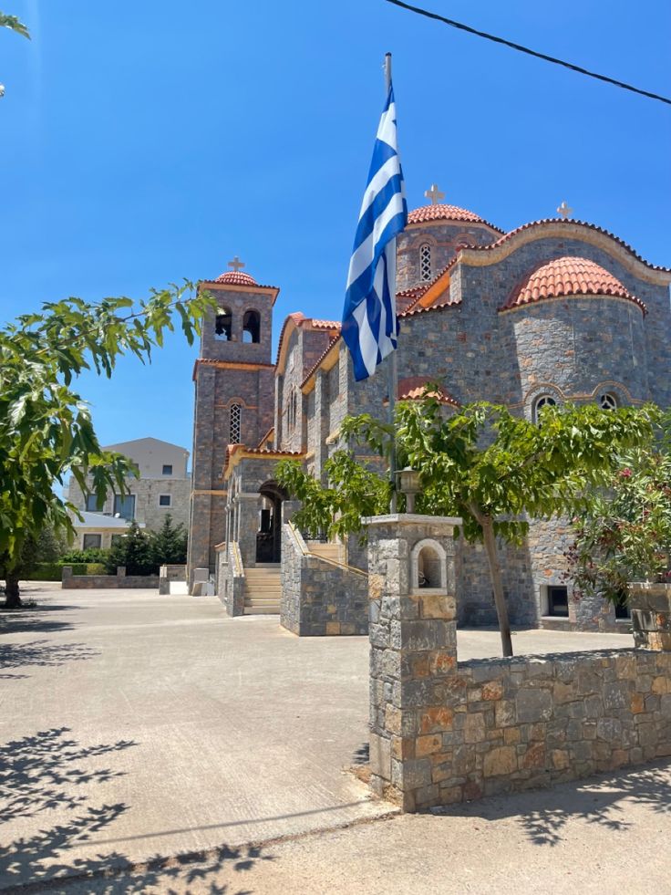 an old stone building with a flag on the outside