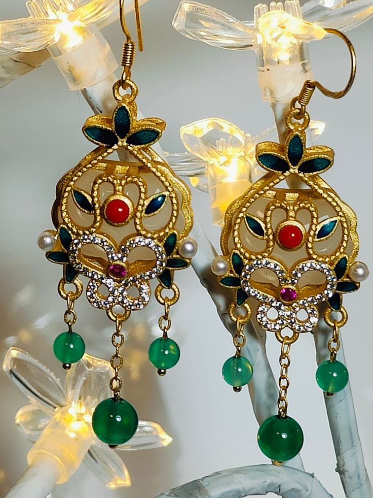 These earrings crafted from green celadon, green agate, and white synthetic stones, intended for your beloved her. Elegant Green Earrings For Festive Occasions, Elegant Green Agate Earrings, Vintage Green Jeweled Earrings, Elegant Agate Drop Earrings, Gold Jade Earrings With Natural Stones, Elegant Green Onyx Drop Earrings, Elegant Green Crystal Earrings For Festive Occasions, Elegant Green Chandelier Earrings For Festive Occasions, Elegant Green Danglers As Gift