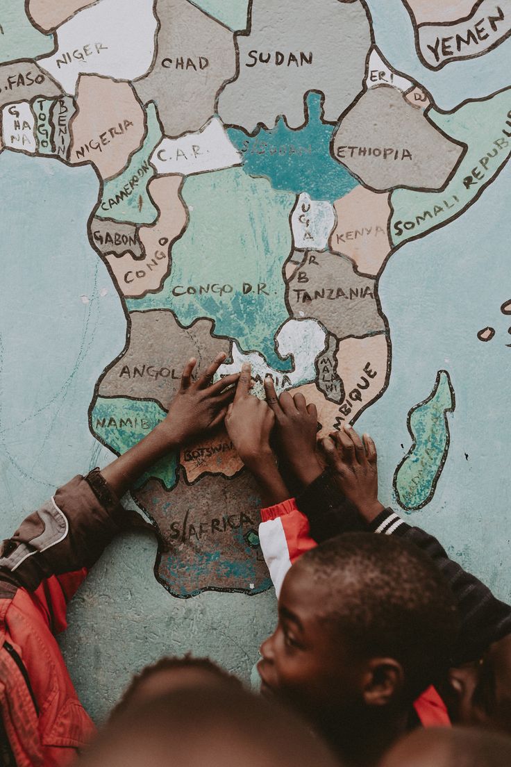 several people writing on a map with africa in the background