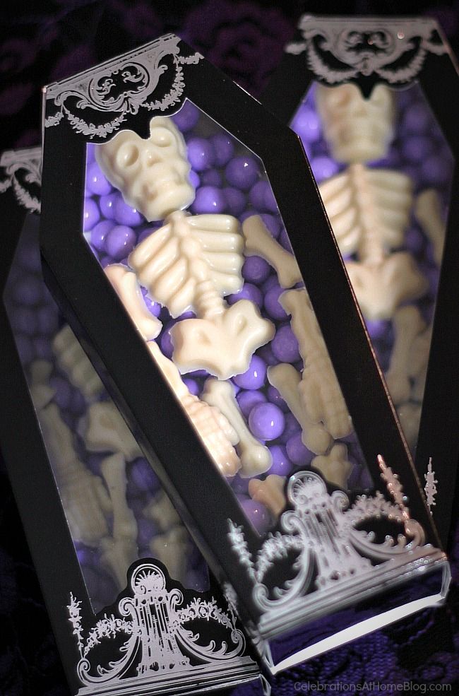 two black boxes filled with purple and white treats