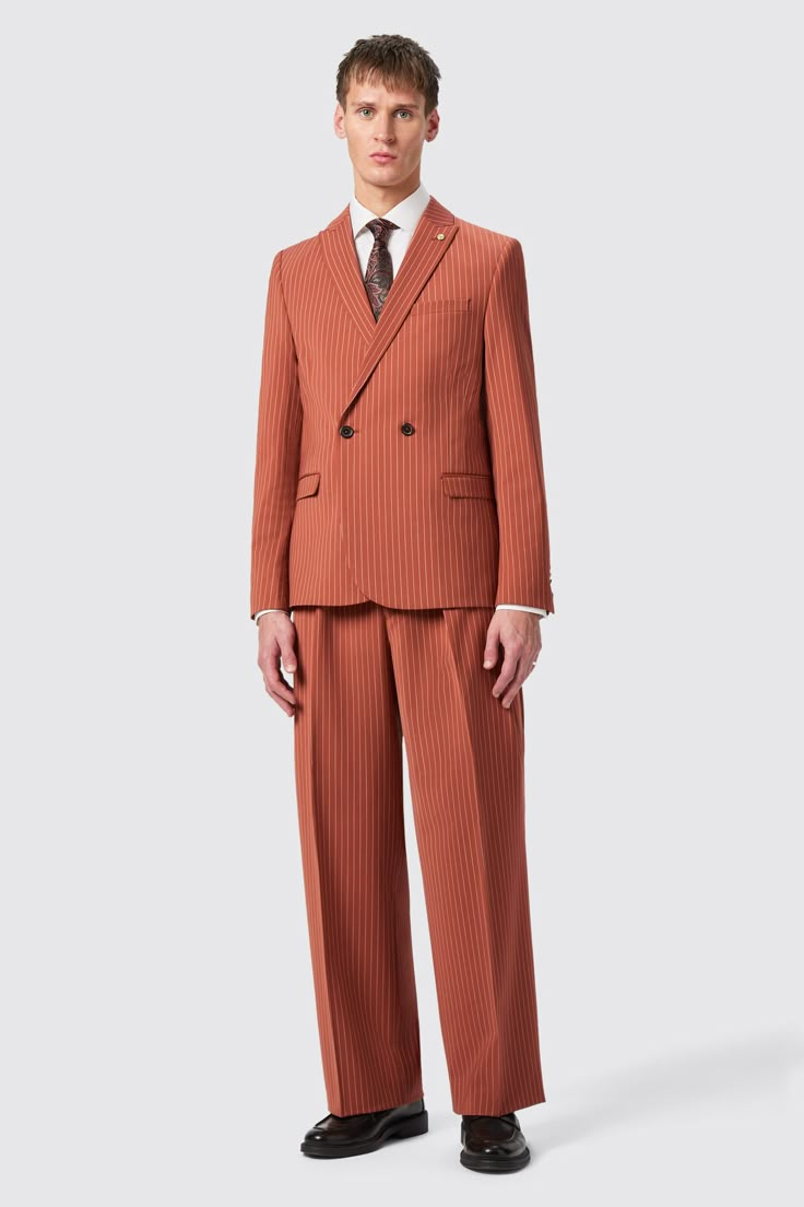 The Cortese oversized suit in rust is designed for the modern man who values both style and functionality. Its elegant pinstripe pattern and tailored fit make it perfect for any formal occasion, ensuring you look sharp and confident. The Cortese is the latest addition to the Twisted Tailor collection and is ideal for business meetings, weddings, or any formal event where you want to make a lasting impression. The double breasted jacket features a peak lapel, straight flap pockets, outer breast welt pockets and double darts. Pair the jacket with the matching straight leg trousers, both designed for a coordinated, polished look. Rust Suits For Men, Orange Suit Mens, Designer Wedding Suits For Men, Oversize Suit, Black Men Suits, Suit Fashion Men's, Double Breasted Suit Men, Peak Lapel Suit, Formal Streetwear