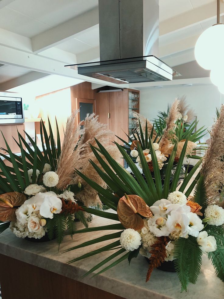 some flowers and plants are sitting on a counter