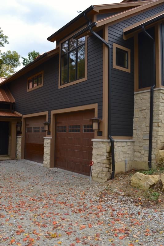 a large house with two garages in the front and one on the other side