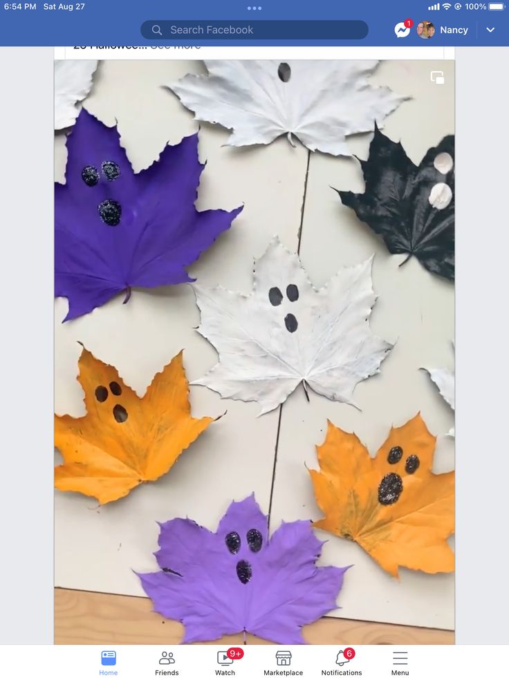 paper leaves are arranged on a table with holes in the middle and buttons at the bottom