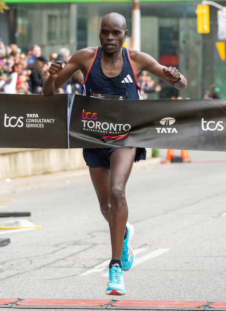 a man running down a street with a banner