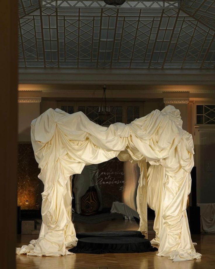 an elaborately decorated room with white drapes