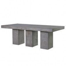 a concrete table sitting on top of a white floor next to two cement pillars with one end missing