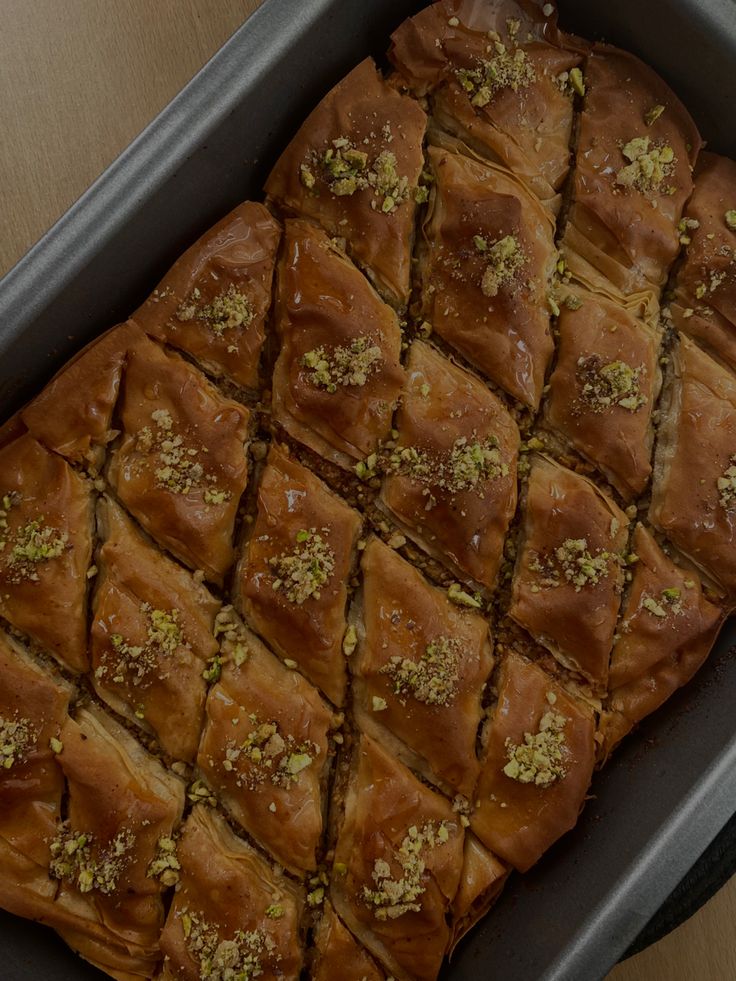 a pan filled with lots of food on top of a table