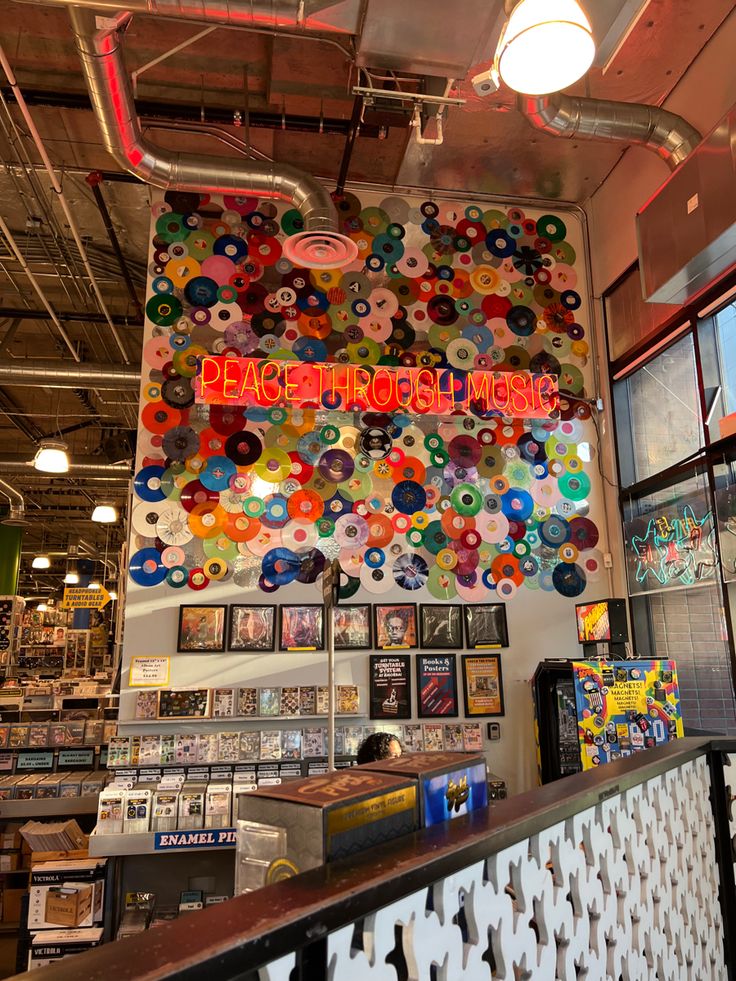 the inside of a store with lots of buttons on the wall and signs hanging from the ceiling