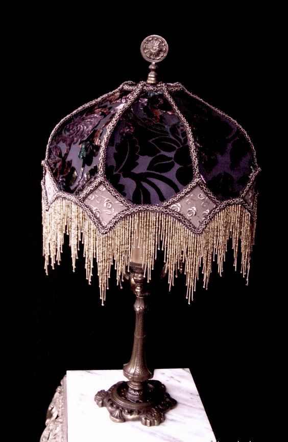 an ornate lamp with fringes and beads on it