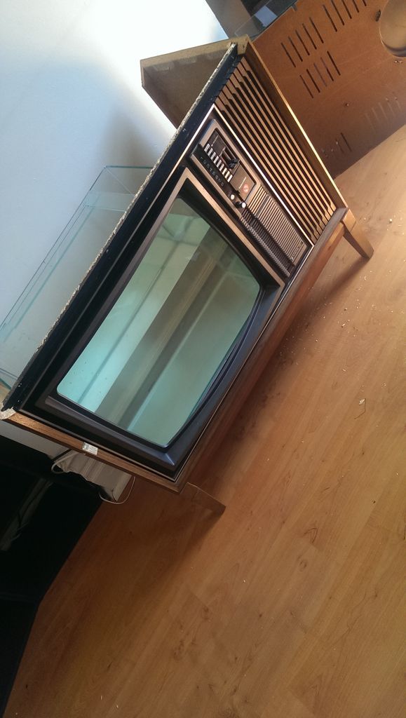 a microwave oven sitting on top of a hard wood floor