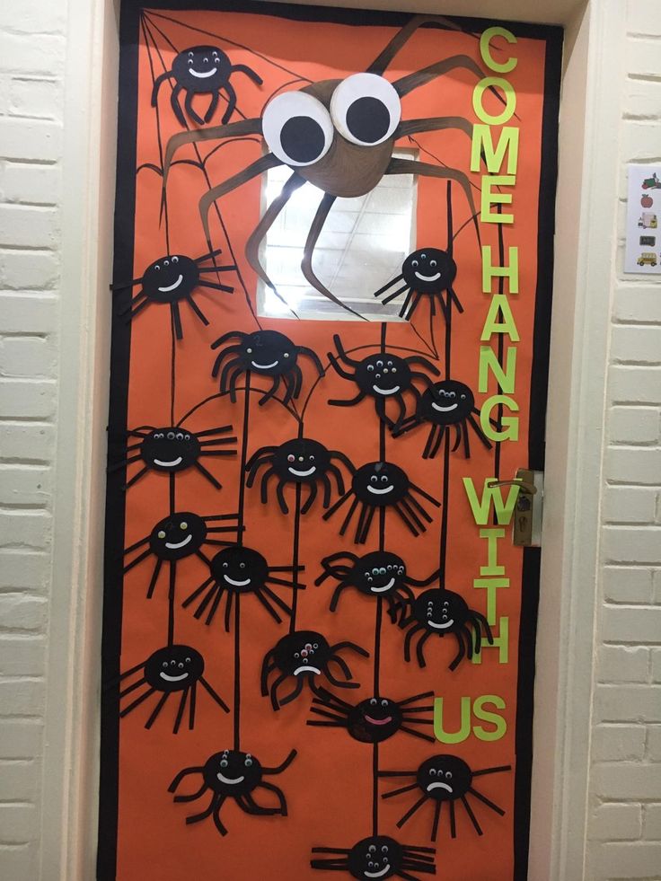 an orange door decorated with black spider legs and eyes