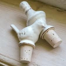 an old white porcelain faucet sitting on top of a wooden doorknob