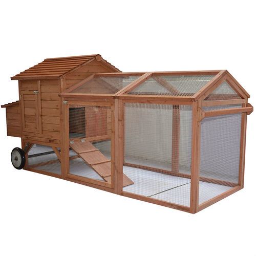 a large wooden chicken coop on wheels with a ramp leading up to the top floor