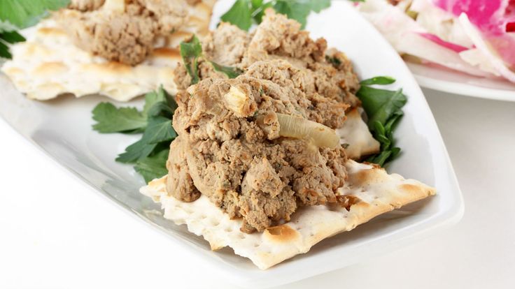 some food is on a white plate with green leaves